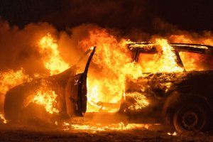 A beautiful shot of a burning car in the desert at night